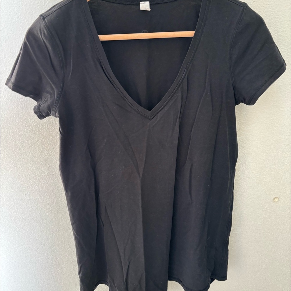 A lululemon T shirt, Black, opens in the front